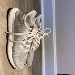 Adidas white tennis shoe.